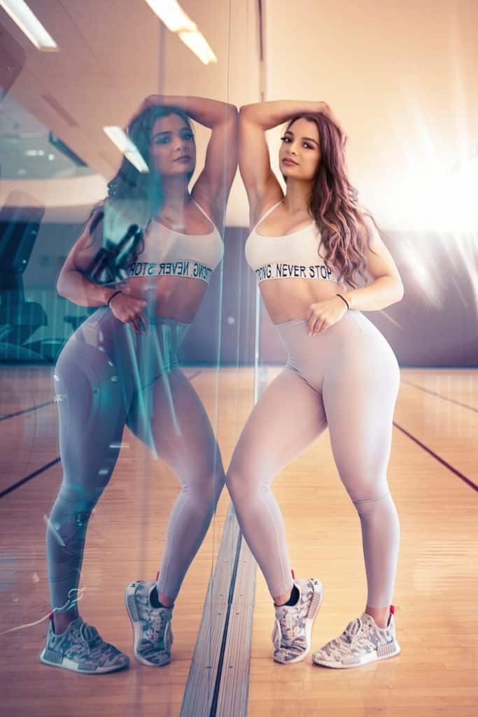 reflection of woman leaning on mirror wall